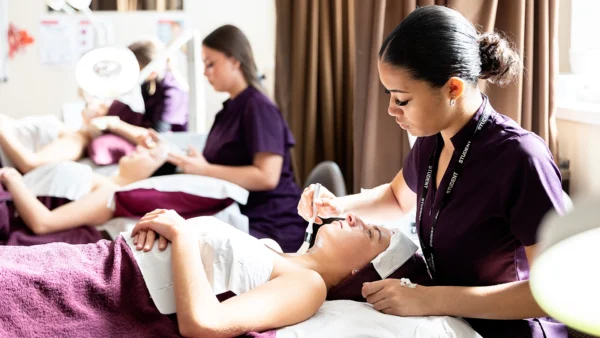 Photo of beauty students applying skin treatment