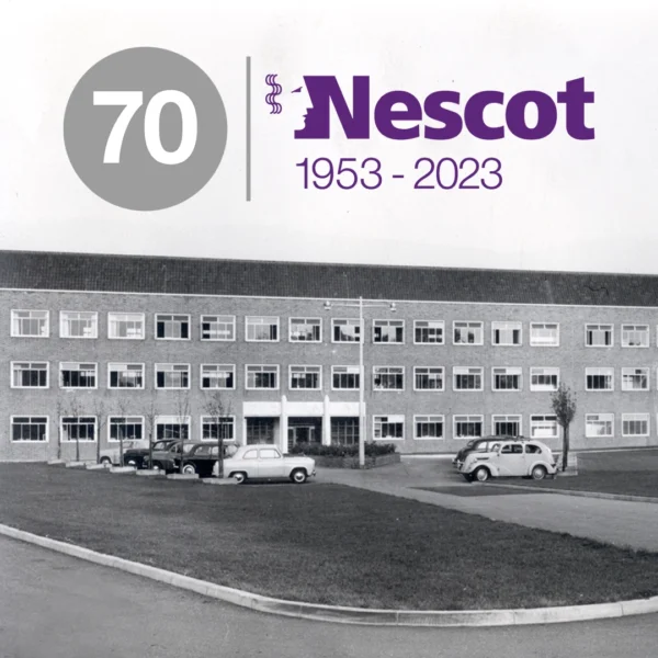 Historic black‑and‑white photo of a three‑storey brick college building with several parked cars in front. Overlaid in the top left is a circular badge with the number 70, and to the right the Nescot logo with the text ‘1953–2023.