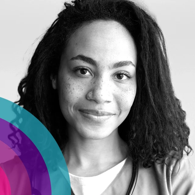 Close-up portrait of a person with curly shoulder-length hair and freckles, looking at the camera, with overlapping colourful circular graphics in the lower left corner on a light background.