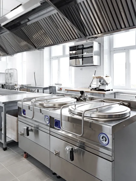 Commercial kitchen with large stainless steel cooking equipment