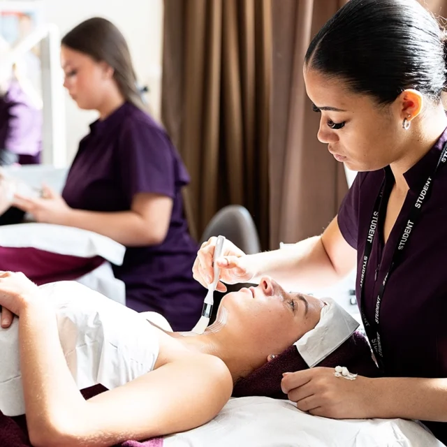 Photo of beauty students applying skin treatment