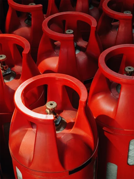 Red LPG gas cylinders grouped closely together
