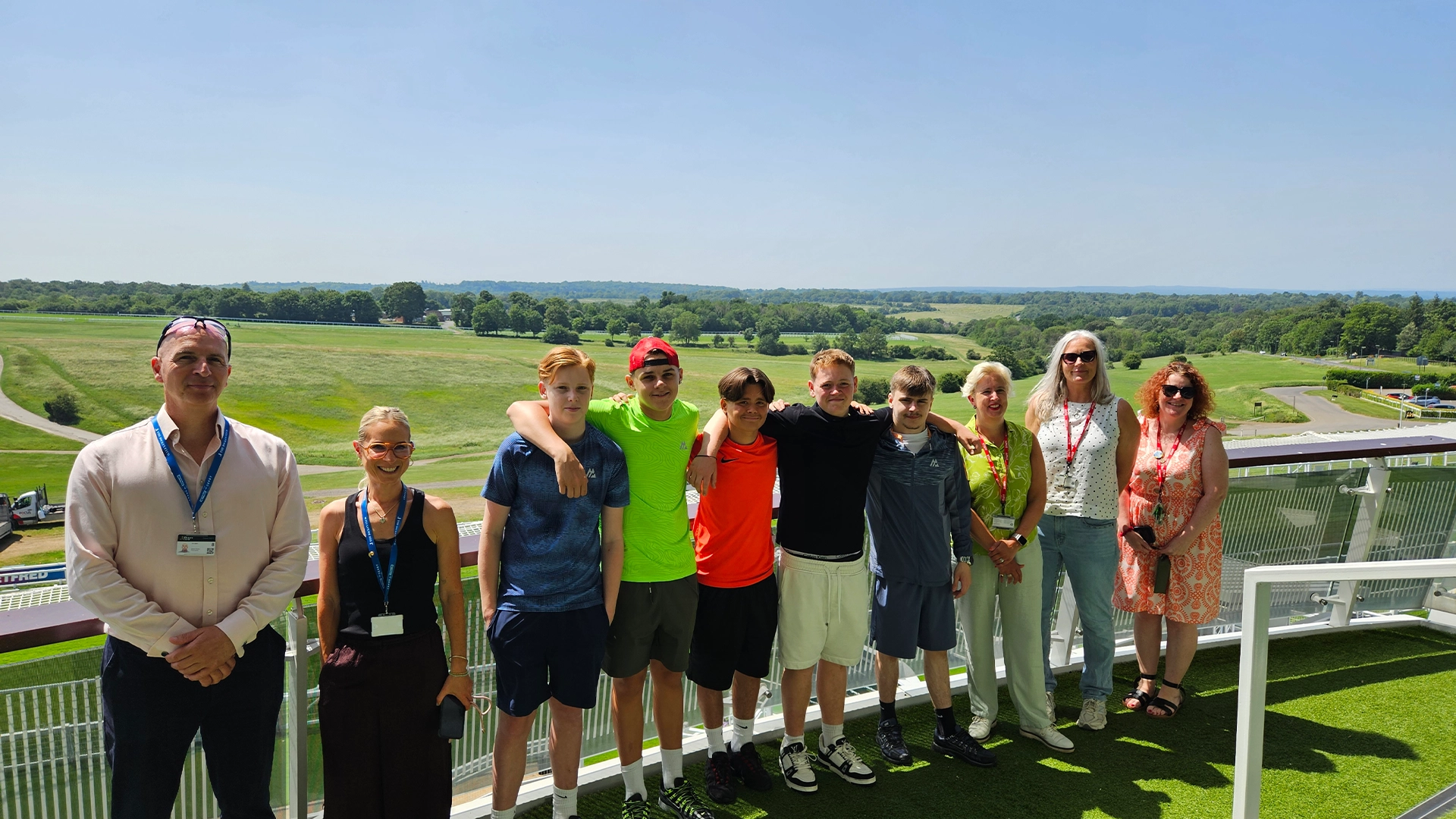 A group image of Nescot students and staff, alongside Epsom Downs Racecourse staff, during a VIP visit of the Queen Elizabeth II Stand at Epsom Racecourse