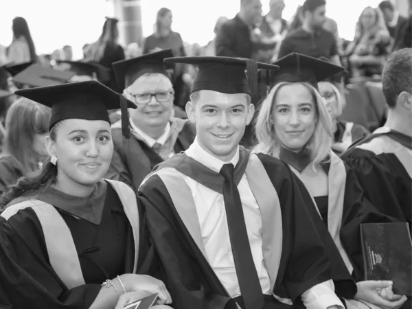 Nescot university-level graduands sat in rows ready for the Nescot graduation ceremony