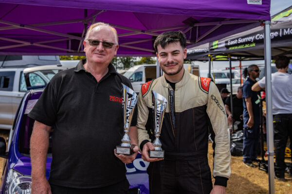 Nescot driver Elliot Lettis and Curriculum Manager George Keith pose with the trophies won at Cadwell Park as part of the Student Motorsport Competition.