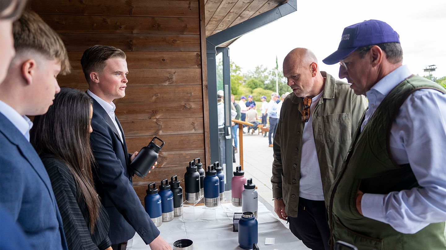 Nescot students demonstrate The WalkBottle to guests at a Peter Jones Foundation charity event, discussing the product's features and the business developed through the Tycoon Enterprise Competition.