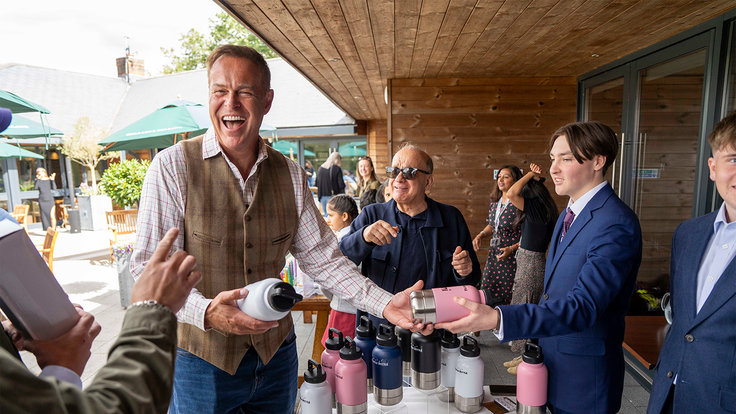 Nescot Business students present personalised WalkBottle products during a networking event hosted by the Peter Jones Foundation, sharing their entrepreneurial journey and business concept.