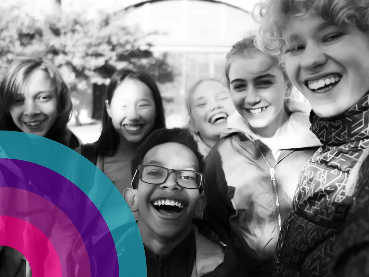Group of young teenagers smiling and laughing.