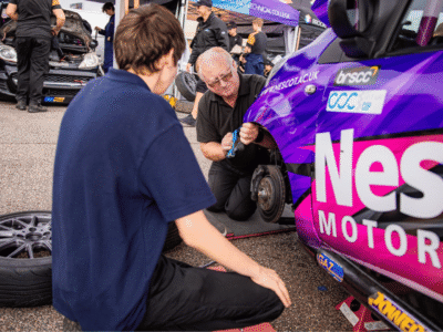 Nescot Motorsport students and tutors prepare the Nescot Motorsport racecar in the paddock at the Snetterton Circuit