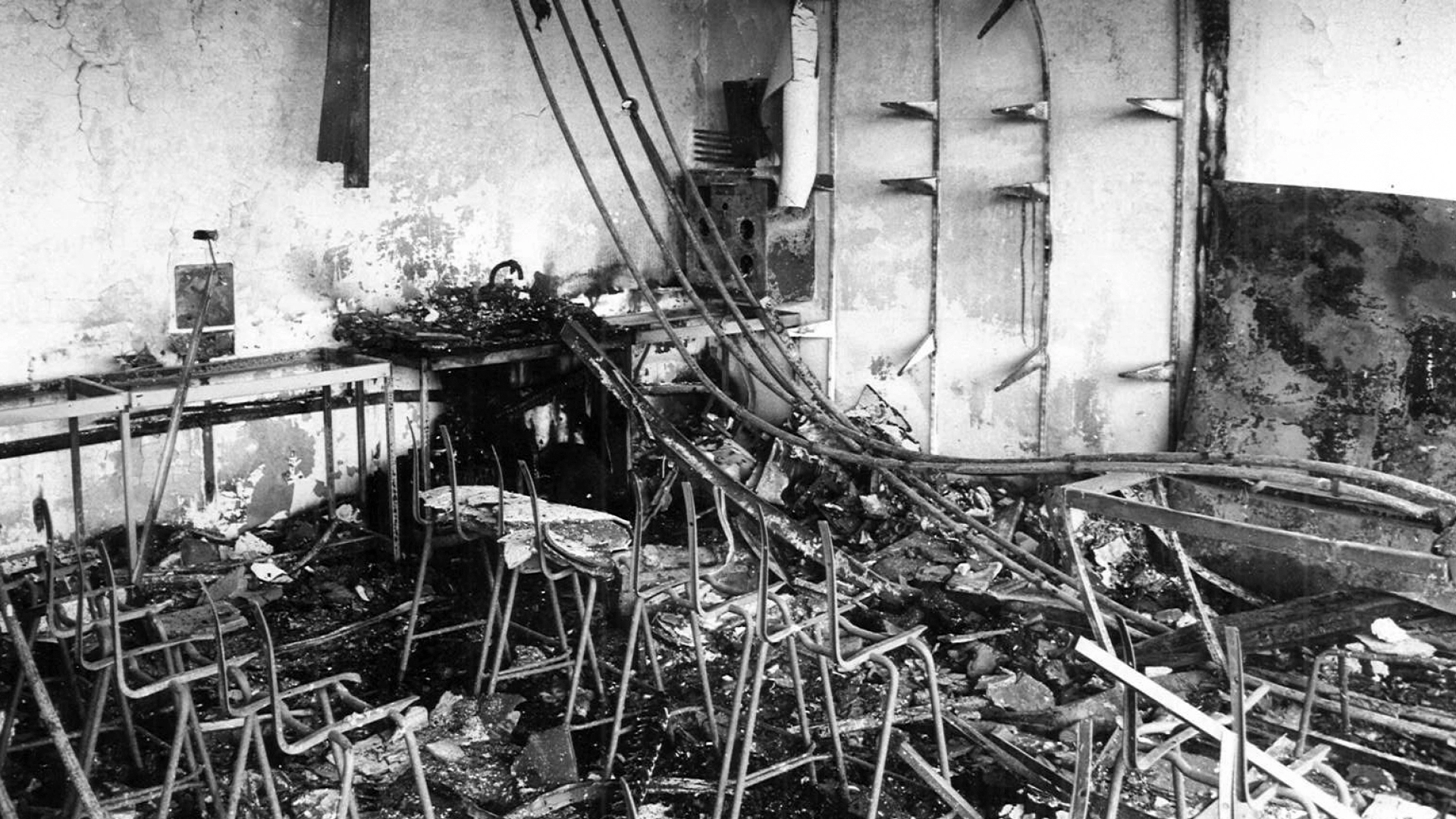 Historic black and white photo showing the damage to a classroom after a fire.